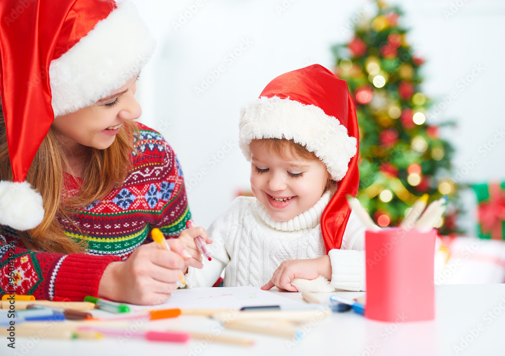 happy family mother and child daughter write aletter to Santa o happy family mother and child daughter write aletter to Santa o
