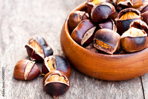 Roasted chestnuts on wooden background