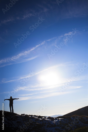 Fototapeta Naklejka Na Ścianę i Meble -  Silhouette woman on top of a high mountain.