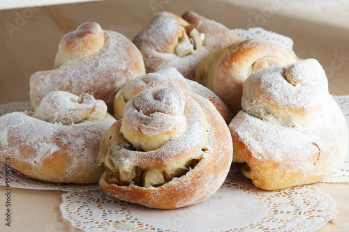 cinnamon roll with apple and powdered sugar