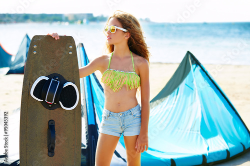 Blond kite surf teen girl in summer beach