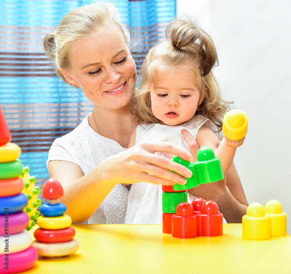 Mother and baby playing and smiling. Happy family.Home interior. Mother and baby playing and smiling. Happy family.Home interior.
