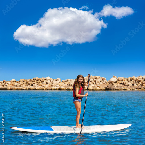 Kid paddle surf surfer girl with row in the beach © lunamarina