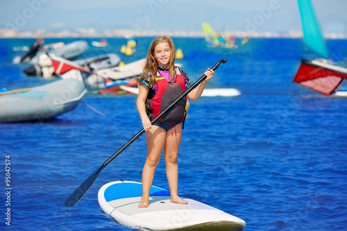 Kid paddle surf surfer girl with row in the beach © lunamarina