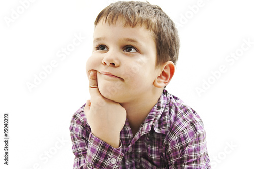 Attractive 6 year old boy making thinking expression. Isolated on white background 