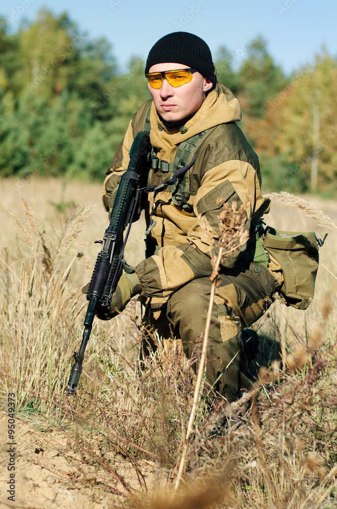 Soldier with a rifle in the field