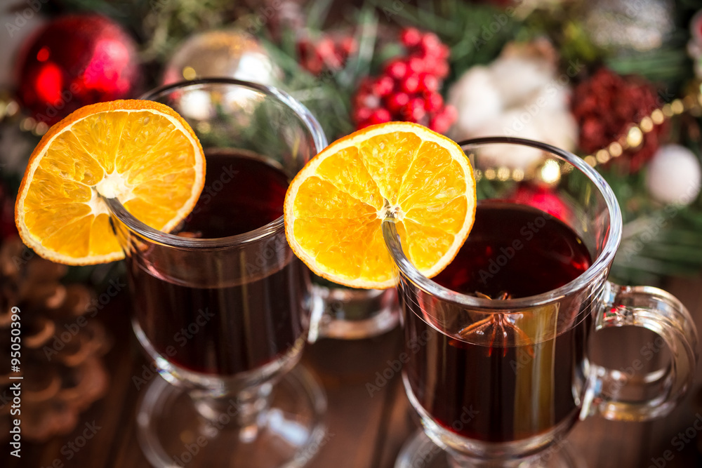Christmas hot mulled wine with spices on a wooden table. The idea for creating greeting cards Christmas hot mulled wine with spices on a wooden table. The idea for creating greeting cards