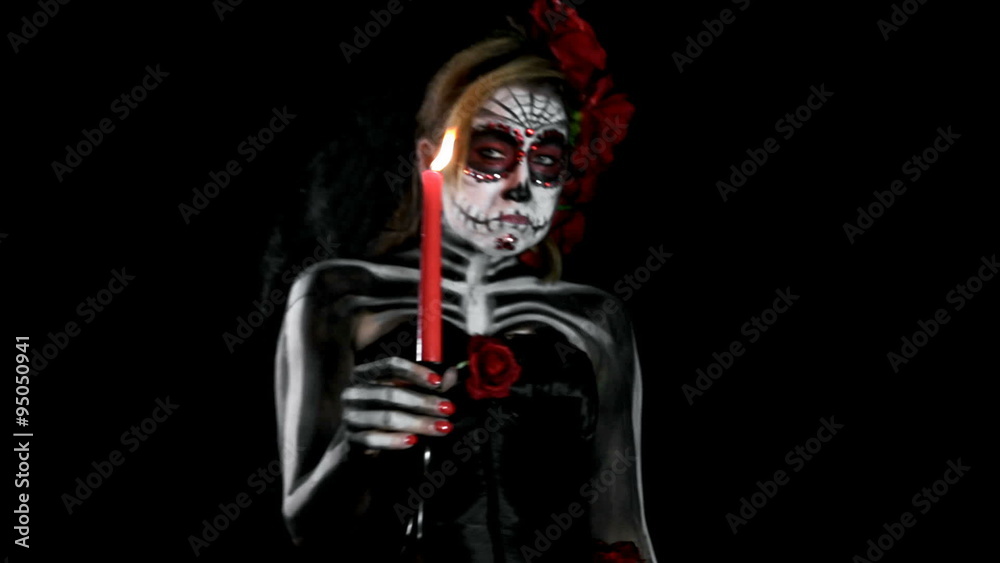 bored female sugar skull with candle, walking through the room