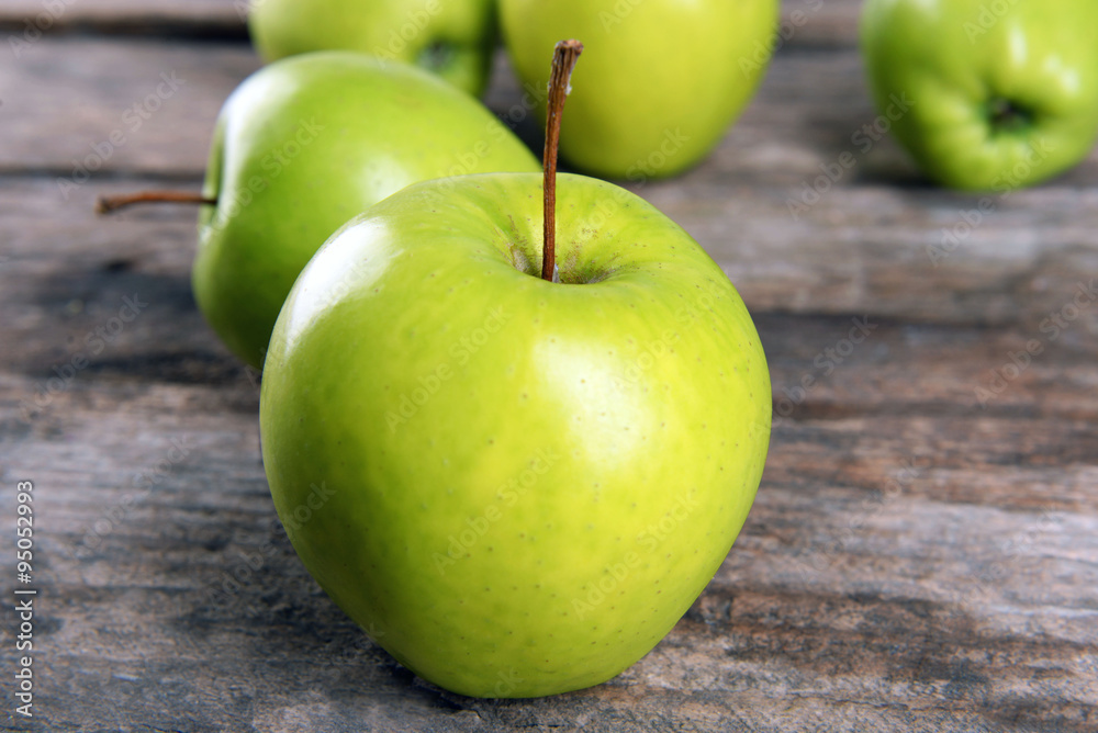 Ripe green apples on wooden table close up Ripe green apples on wooden table close up