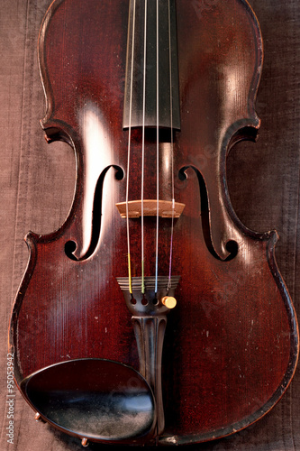 Antique violin against gray background