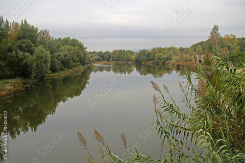 Reflections in Ter River, in Girona, one of autumn day photo