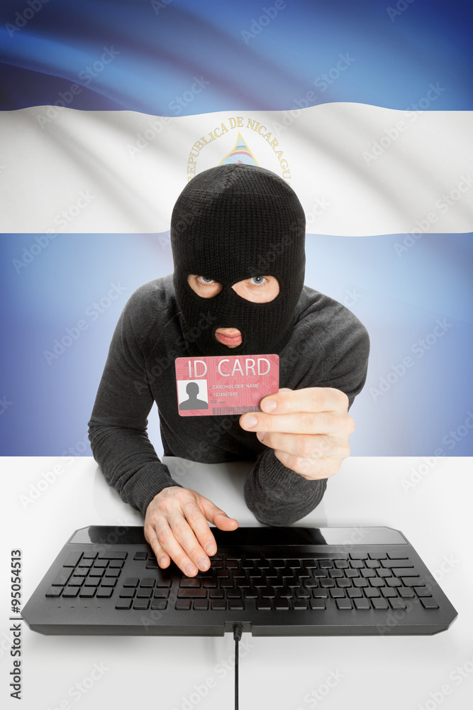 Hacker with flag on background holding ID card in hand - Nicaragua Hacker with flag on background holding ID card in hand - Nicaragua