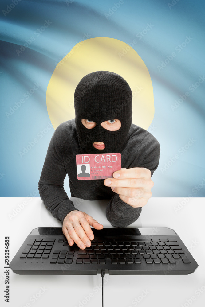 Hacker with flag on background holding ID card in hand - Palau Hacker with flag on background holding ID card in hand - Palau