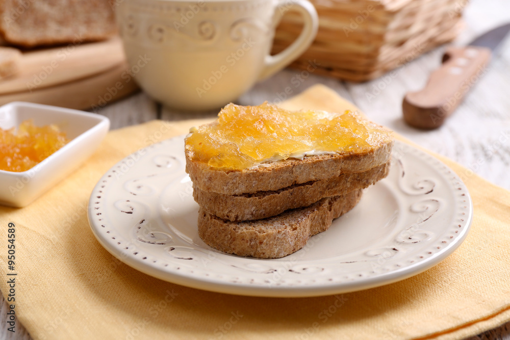 Fresh toast with butter and jam on table close up
