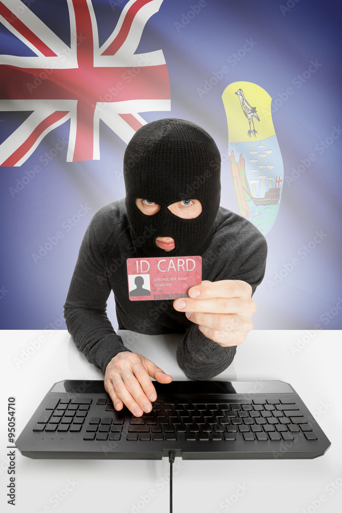 Hacker with flag on background holding ID card in hand - Saint Helena Hacker with flag on background holding ID card in hand - Saint Helena