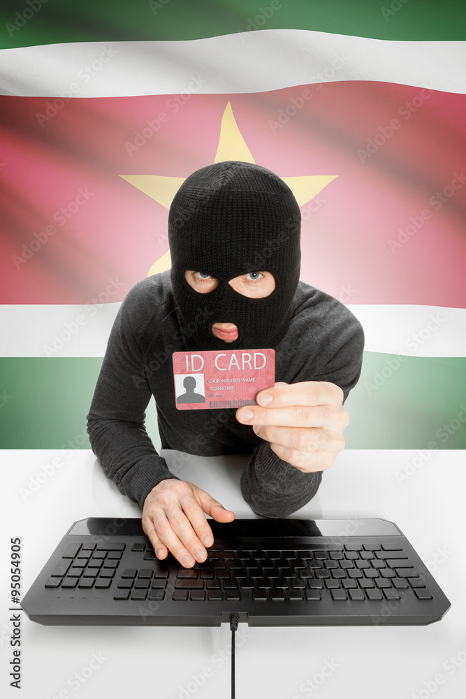 Hacker with flag on background holding ID card in hand - Suriname Hacker with flag on background holding ID card in hand - Suriname