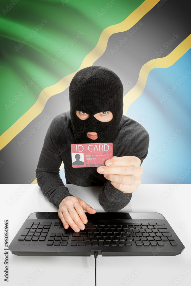 Hacker with flag on background holding ID card in hand - Tanzania Hacker with flag on background holding ID card in hand - Tanzania