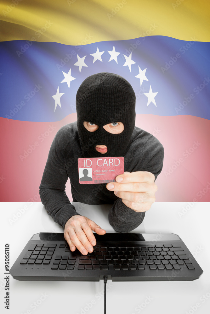 Hacker with flag on background holding ID card in hand - Venezuela Hacker with flag on background holding ID card in hand - Venezuela