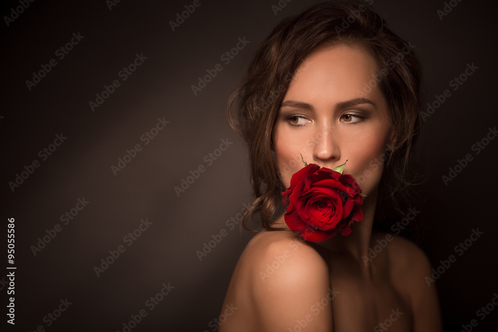 Portrait of professional model girl with red rose