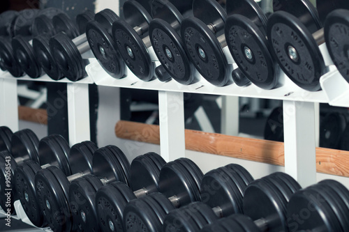 Close-up view of barbells organized in row