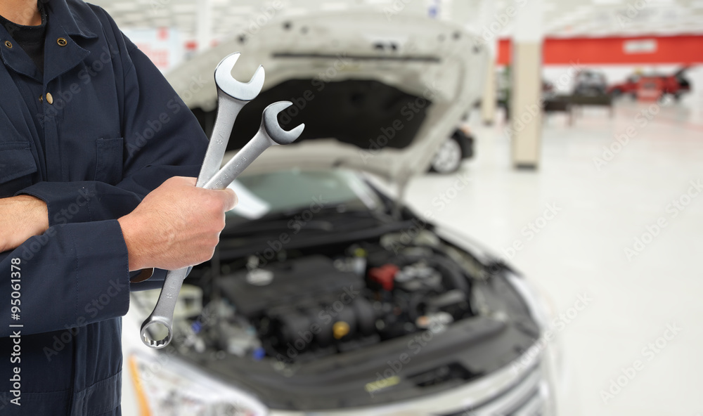 Hand of car mechanic in auto repair service. Hand of car mechanic in auto repair service.