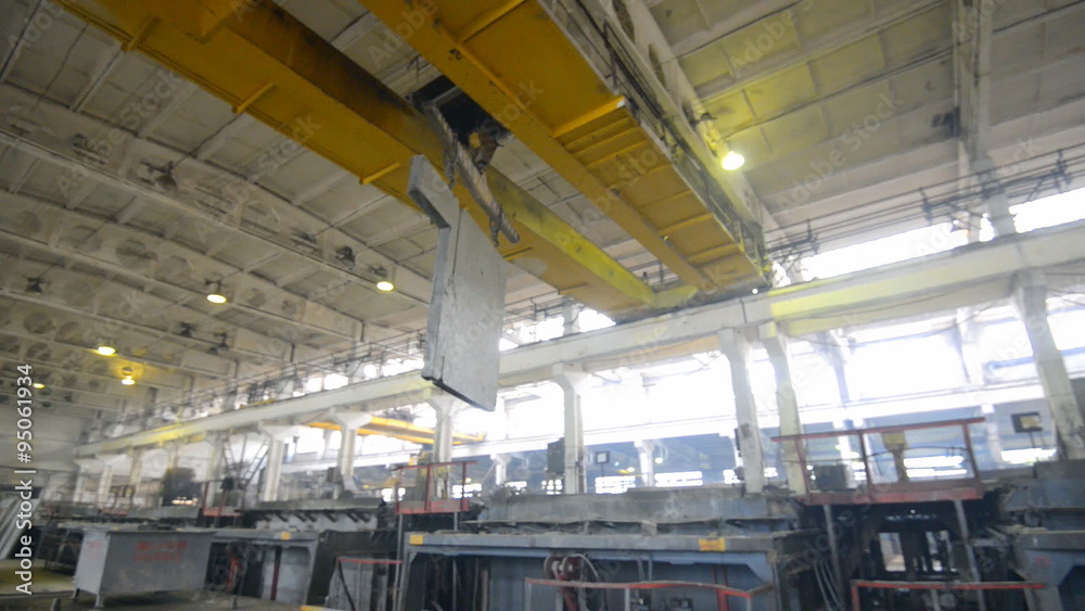 Bridge crane rides on factory floor Bridge crane rides on factory floor