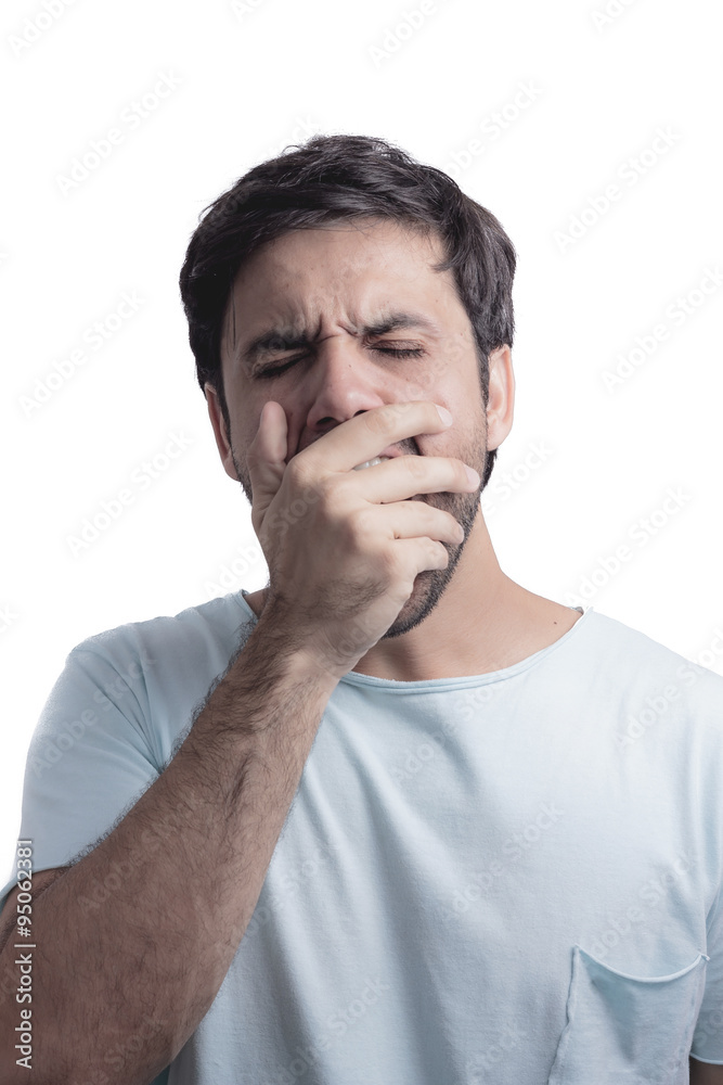 Young man yawning with his hand on face Young man yawning with his hand on face
