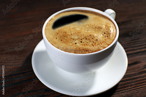 Cup of coffee on wooden background