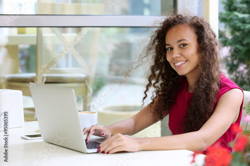 Young pretty business woman with laptop in the restaurant Free Download Young pretty business woman with laptop in the restaurant - GFXLoad