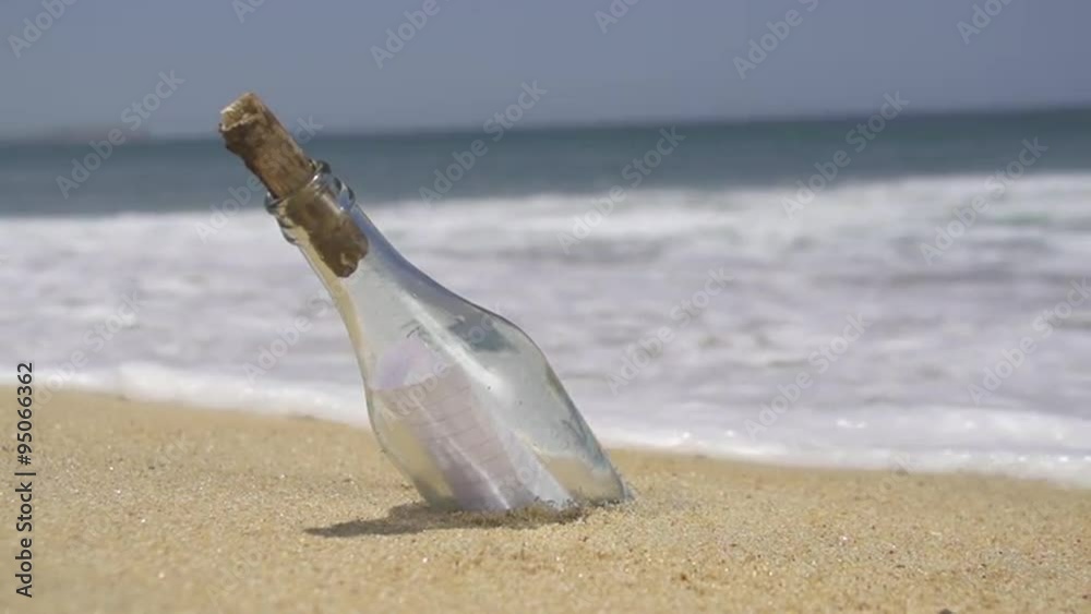 SLOW MOTION: Stranded bottle on the beach