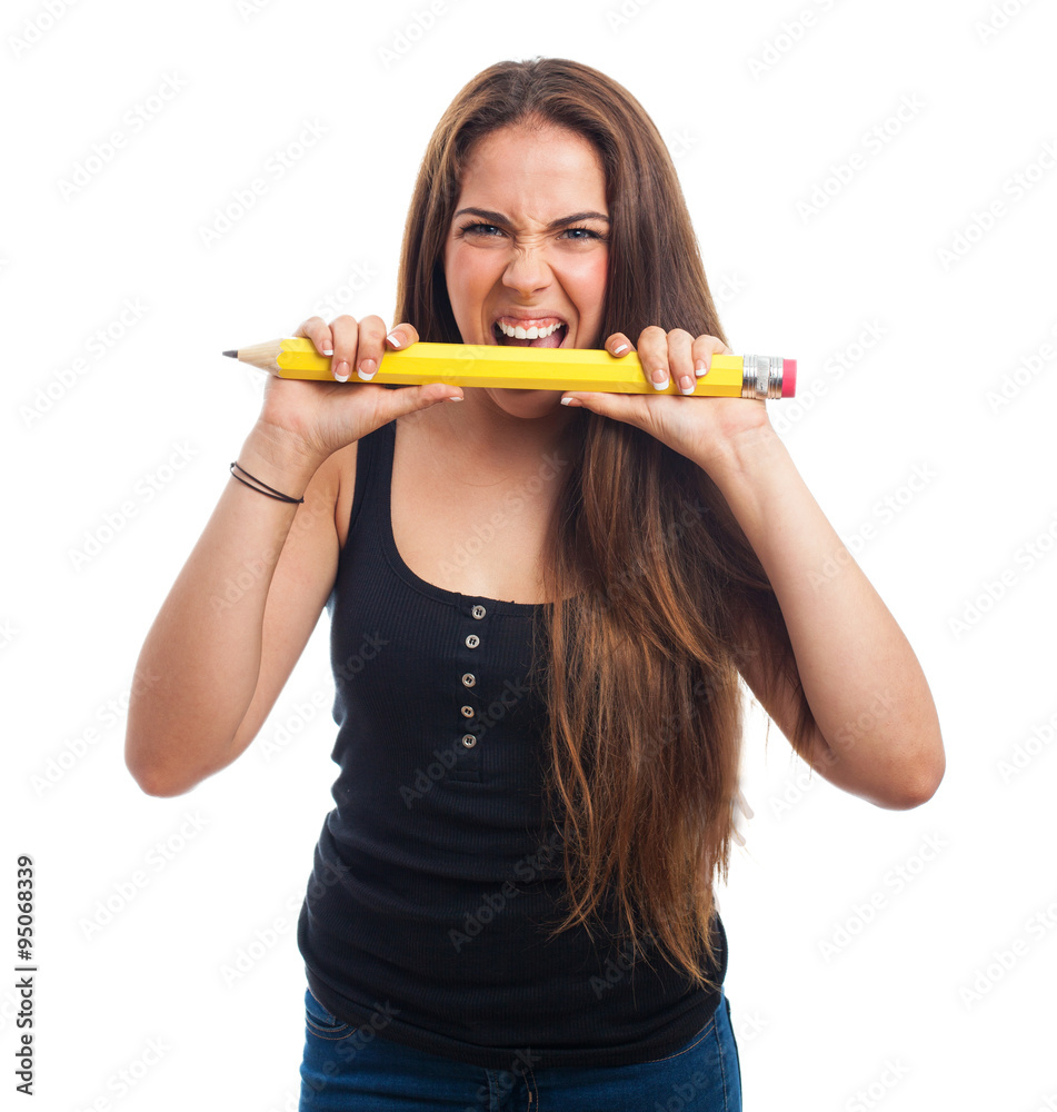 young woman biting a big pencil young woman biting a big pencil