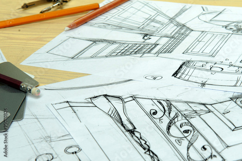 Drawings, sketches, pencils, stationery on the table.