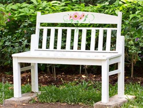 White wooden chair in garden. photo