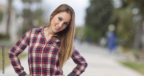 beautiful young woman posing and wearing plaid shirt