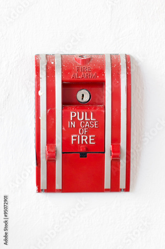 Red fire alarm pull switch isolated on white.