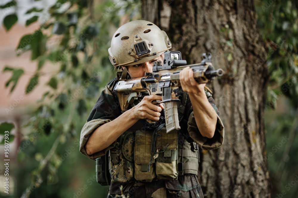 Soldier aiming his rifle on battlefield background Soldier aiming his rifle on battlefield background