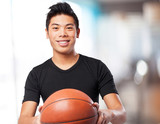 happy chinese sport man with basket ball
