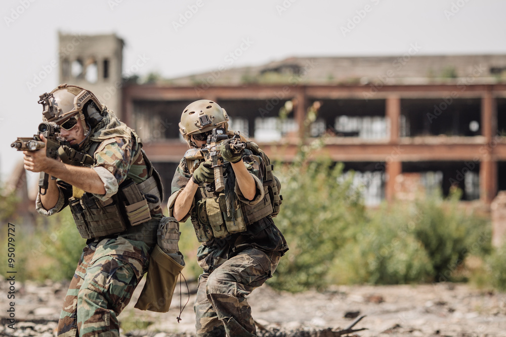 Fototapeta premium Private Military Contractor on patrol in destroyed city