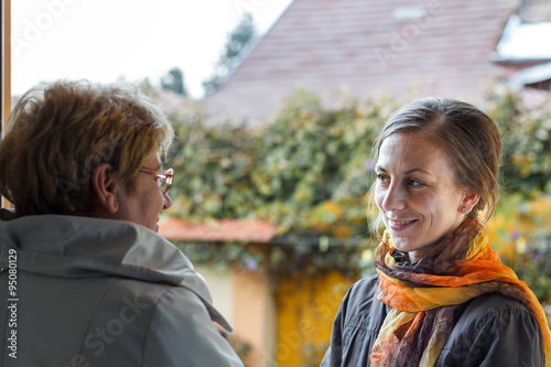 Women greeting girl