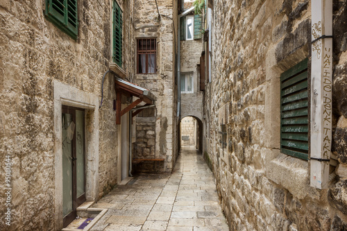 Narrow and empty alley or pedestrian street at the Old Town in Split  Croatia.