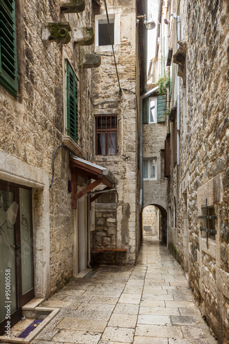 Narrow and empty alley or pedestrian street at the Old Town in Split, Croatia. © tuomaslehtinen