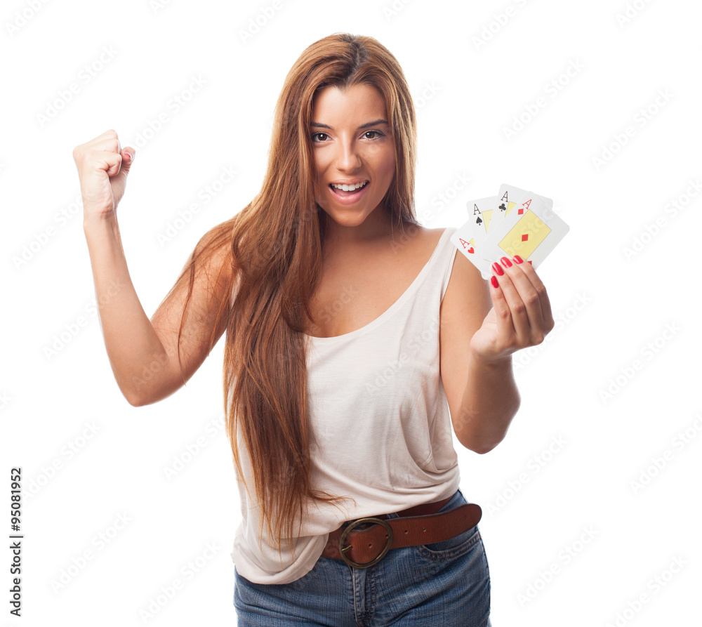 Obraz premium portrait of a young woman playing poker and doing a winner gestu