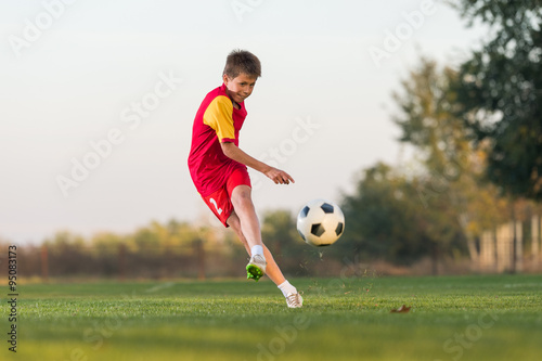 kid kicking a soccer ball © Dusan Kostic