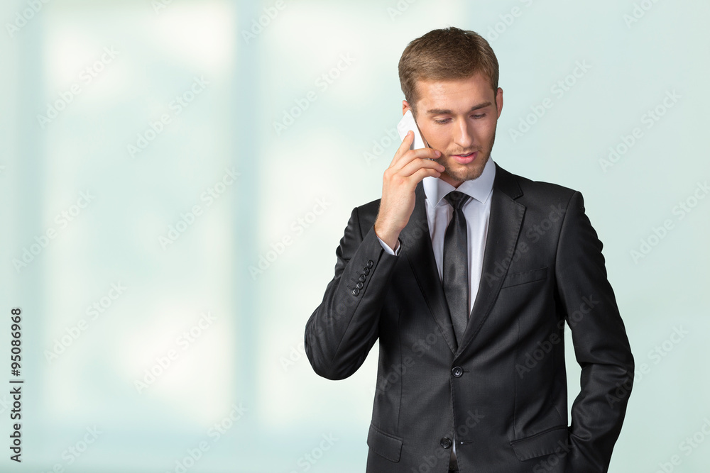 Young handsome businessman talking on mobile phone Young handsome businessman talking on mobile phone