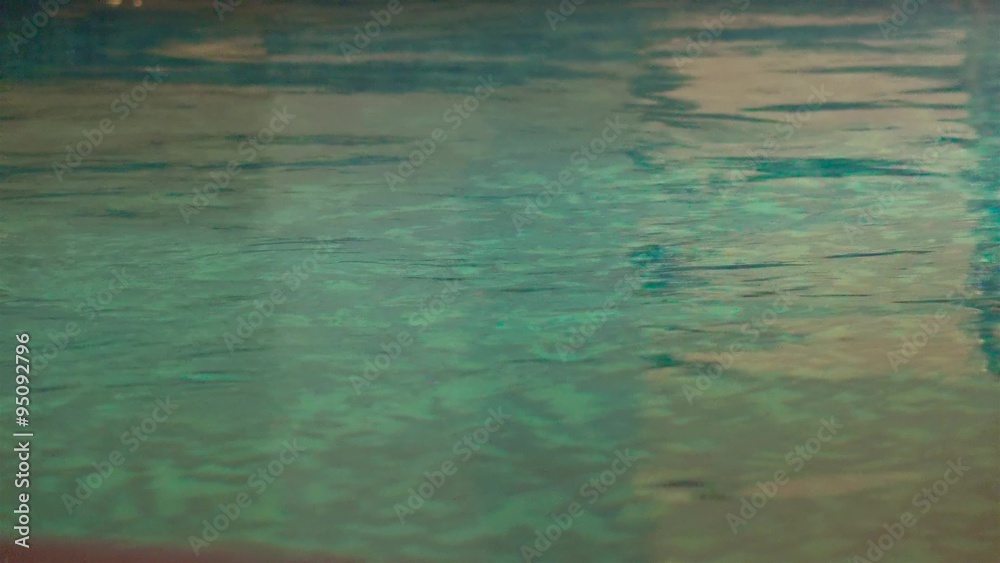 Swimming pool surface with reflection. Dark atmosphere 