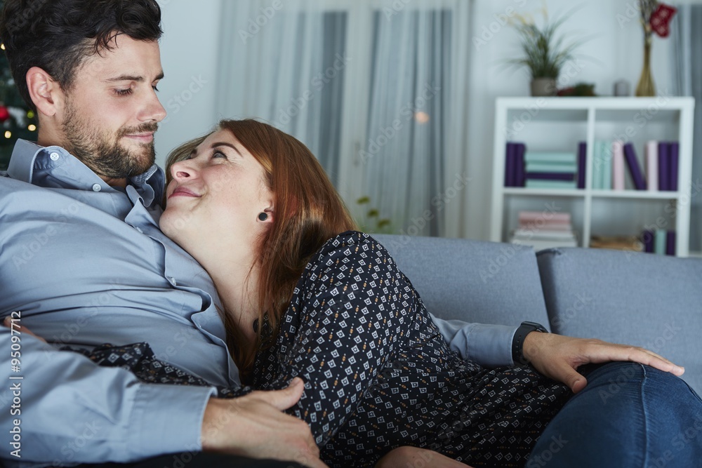 young happy couple hug on sofa young happy couple hug on sofa
