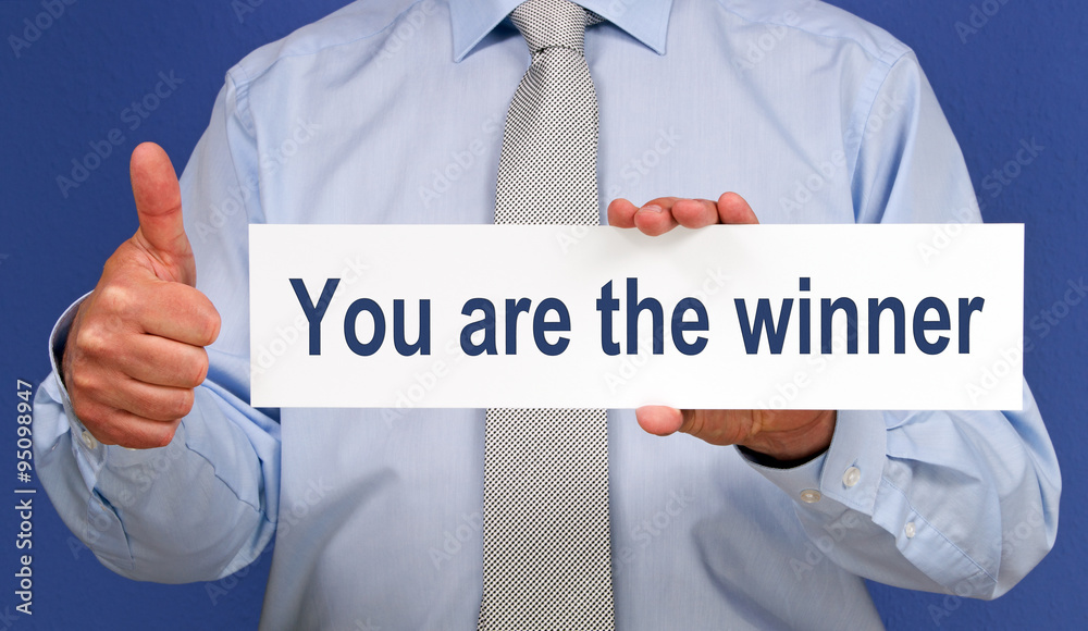 You are the winner - Businessman with sign and thumb up You are the winner - Businessman with sign and thumb up