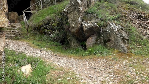 Stairs to hidden underground unexplored cave in  photo