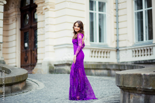 Beautiful brunette young woman wearing dress and walking on the © ostap_davydiak