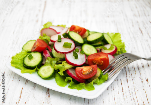 Spring salad with tomato, cucumbers and radish